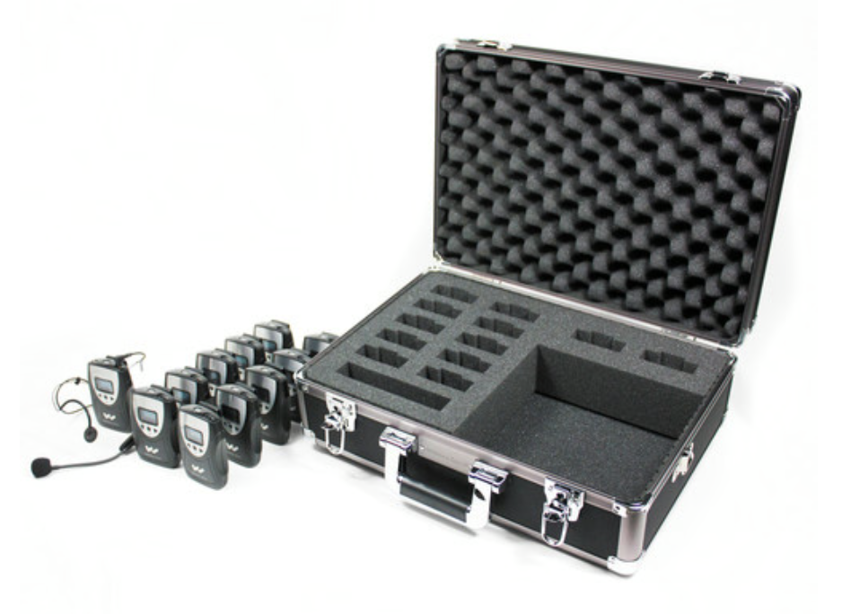 An assistive listening system, with hard case, a mic and transmitter, and several receivers.