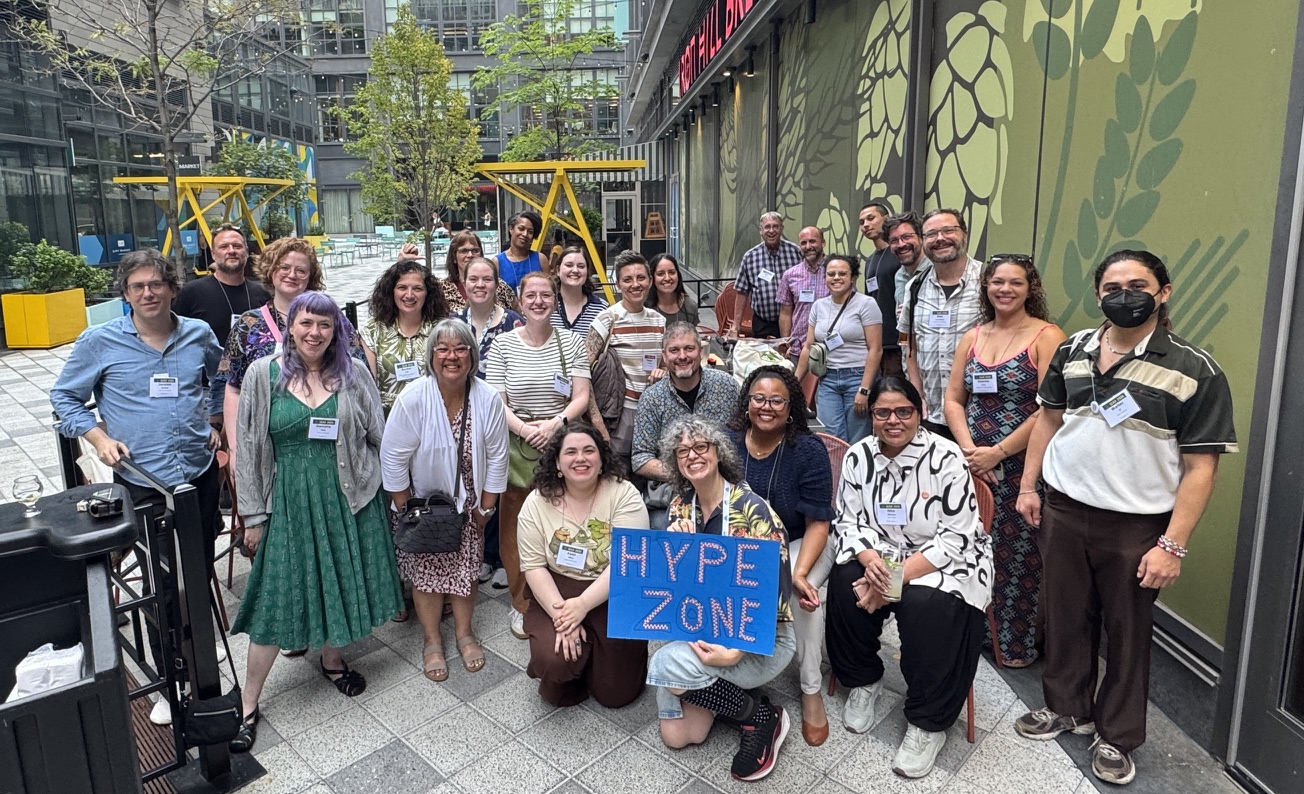 Photo of Illinois arts & culture workers at LEAD smiling at the camera in an open courtyard.